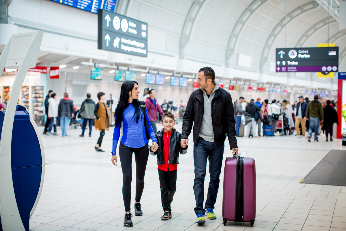 Family walking through Pearson International Airport Terminal